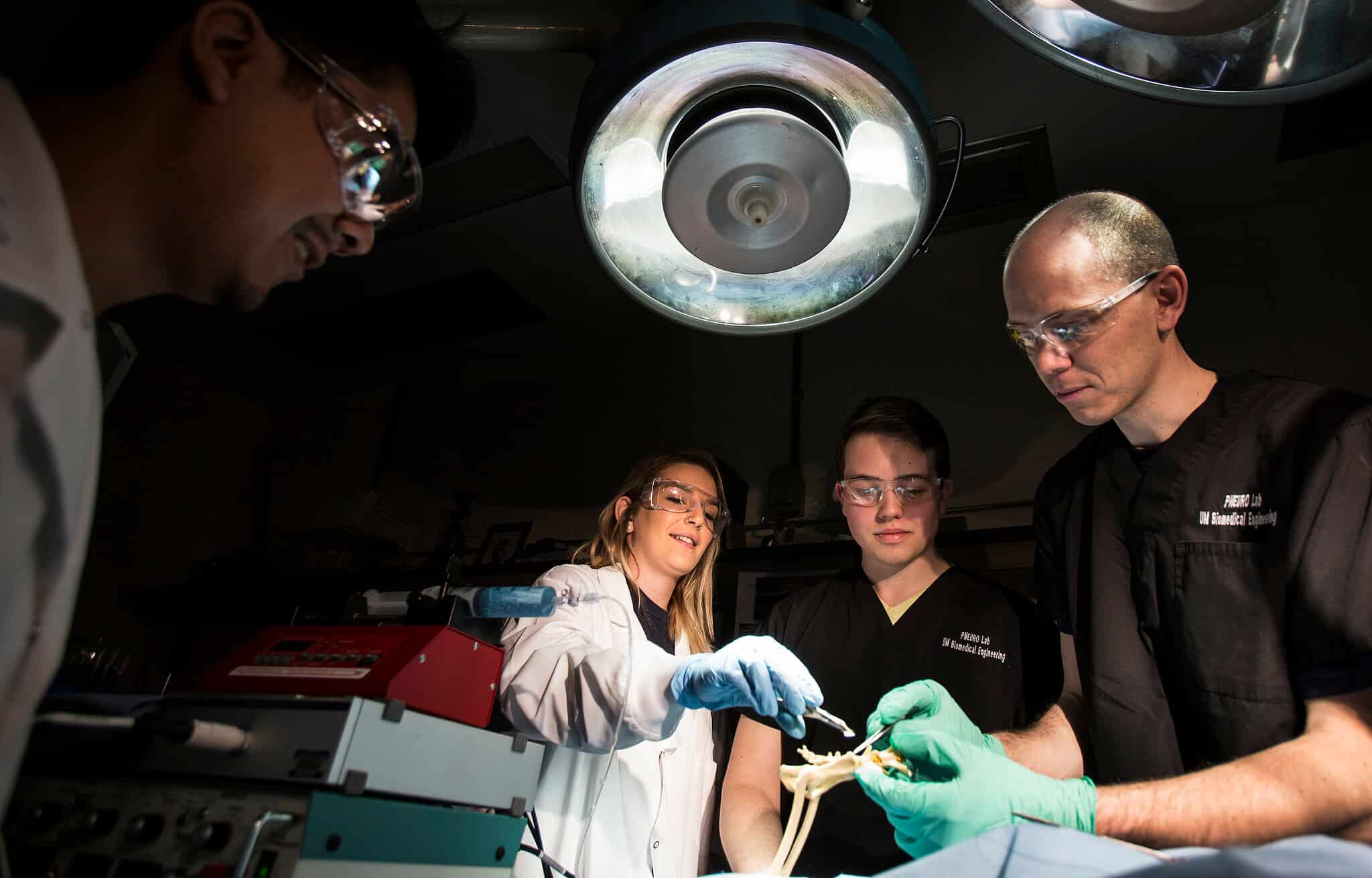 Students and faculty performing a surgical task