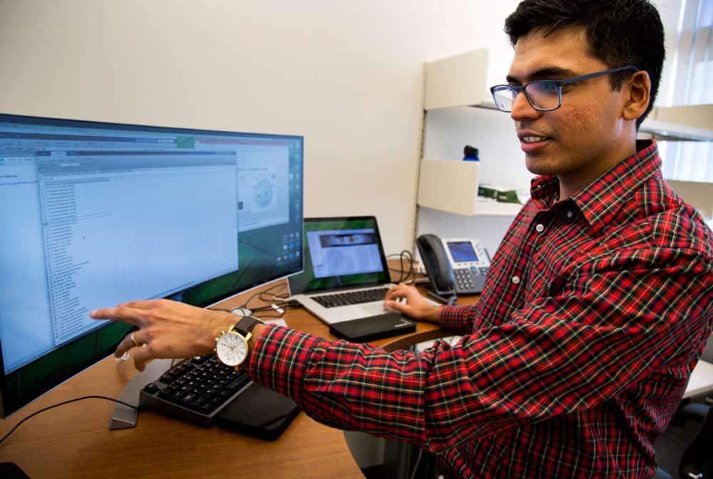 Sriram Chandrasekaran in front of a computer monitor